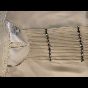 Cream pleated sleeveless top with rhinestones